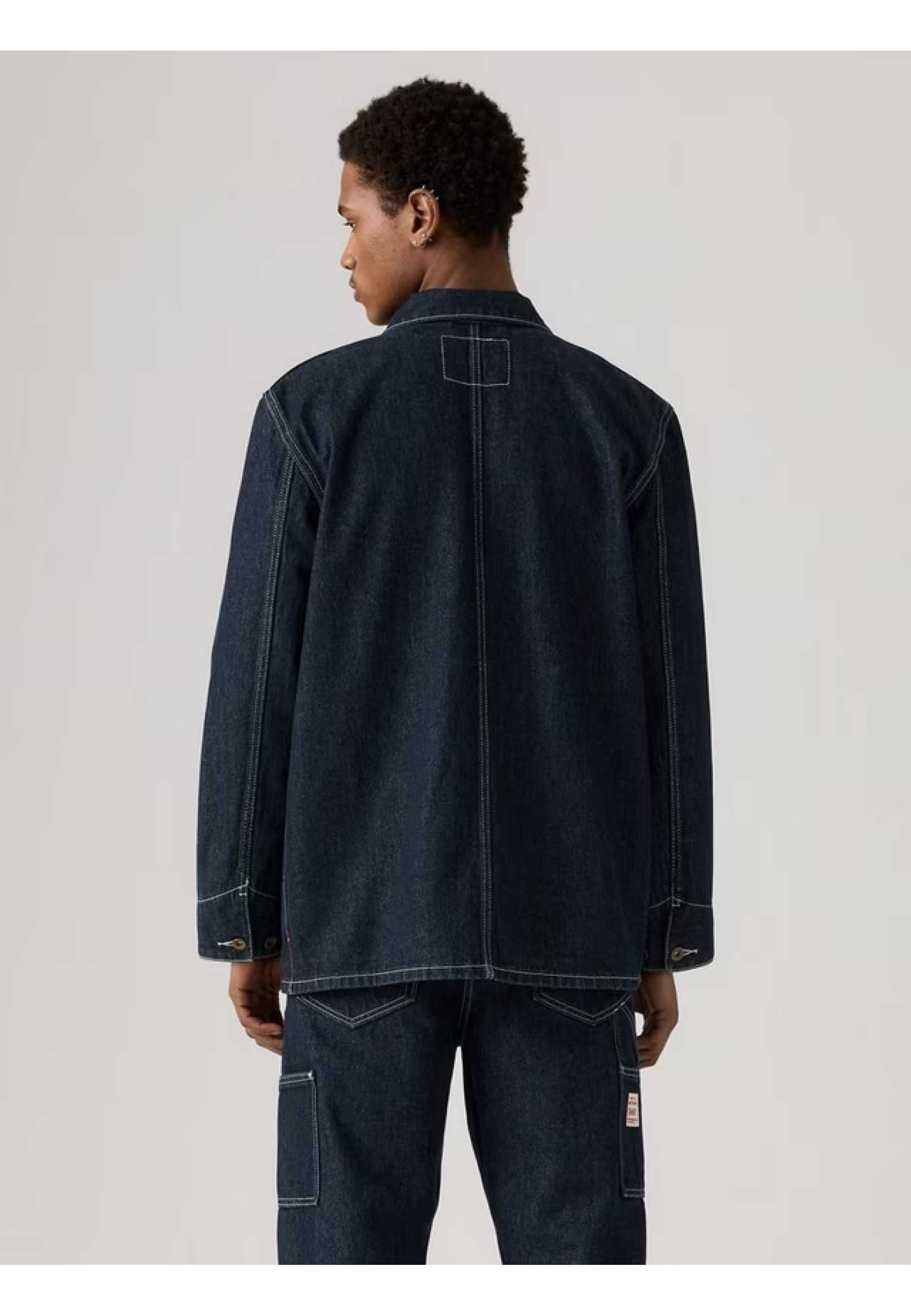 Man wearing Levi's Berkley Chore Coat Dark Wash with jeans and boots